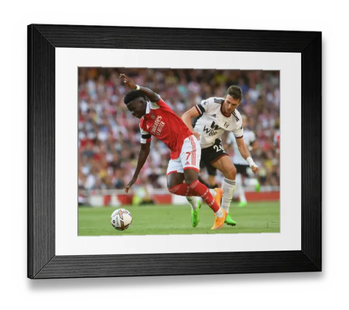 Framed Print : Arsenal's Bukayo Saka Faces Off Against Fulham's Joao Palhinha in Premier League Clash