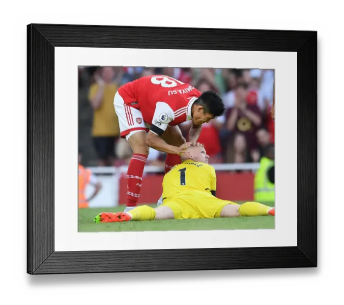 Framed Print : Arsenal Celebrate: Tomiyasu and Ramsdale Embrace Post-Goal at Emirates Stadium