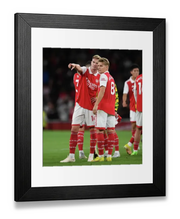 Framed Print : Arsenal's Holding and Odegaard Celebrate Victory Over Aston Villa in 2022-23 Premier League