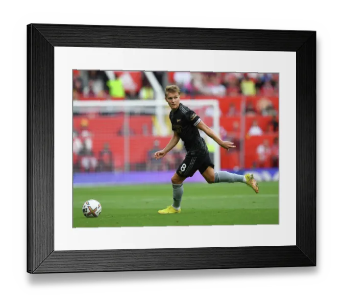 Framed Print : Arsenal's Martin Odegaard Goes Head-to-Head with Manchester United in Premier League Clash (2022-23)