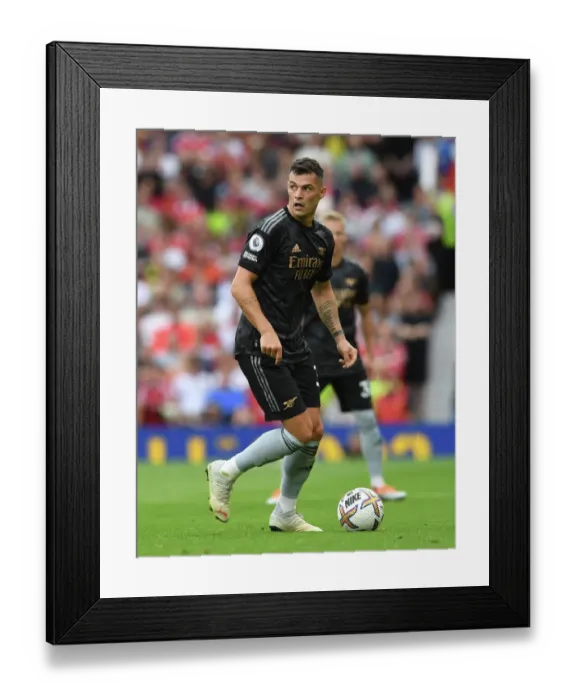 Framed Print : Arsenal's Xhaka Faces Off Against Manchester United at Old Trafford (2022-23 Premier League)