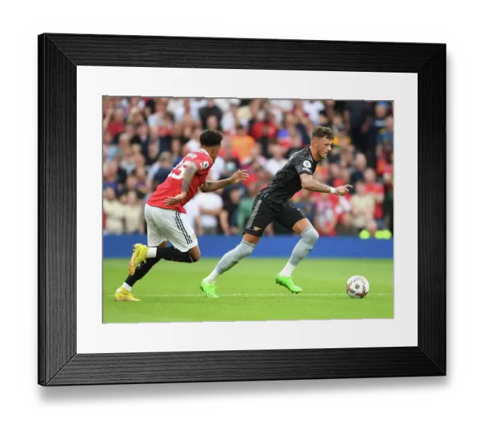 Framed Print : Arsenal's Ben White Outsmarts Jadon Sancho: A Premier League Victory for the Gunners (2022-23)