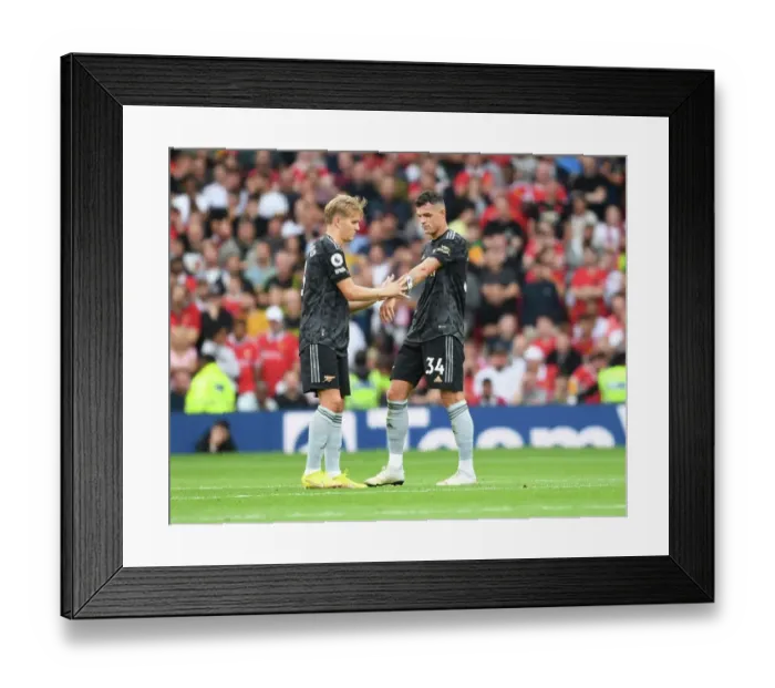 Framed Print : Arsenal's Xhaka Passes Captaincy to Odegaard in Manchester United Clash (2022-23) Framed Print : Arsenal's Xhaka Passes Captaincy to Odegaard in Manchester United Clash (2022-23)