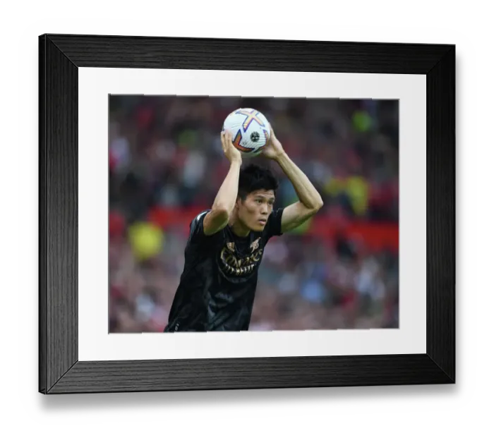 Framed Print : Tomiyasu vs Manchester United: Arsenal's Defender Stands Firm in Premier League Showdown (2022-23)