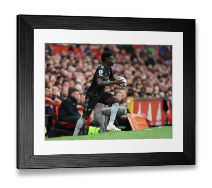 Framed Print : Bukayo Saka in Action: A Football Battle at Old Trafford - Manchester United vs. Arsenal, Premier League 2022-23