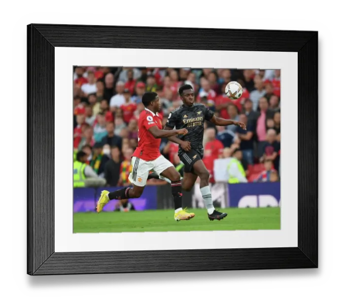 Framed Print : Nketiah vs Malacia: A Premier League Showdown - Arsenal vs Manchester United at Old Trafford (2022-23) Framed Print : Nketiah vs Malacia: A Premier League Showdown - Arsenal vs Manchester United at Old Trafford (2022-23)