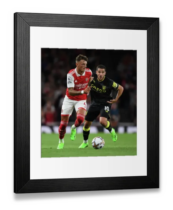 Framed Print : Arsenal's Ben White Outmuscles Aston Villa's Emiliano Buendia during the 2022-23 Premier League Clash at Emirates Stadium Framed Print : Arsenal's Ben White Outmuscles Aston Villa's Emiliano Buendia during the 2022-23 Premier League Clash at Emirates Stadium
