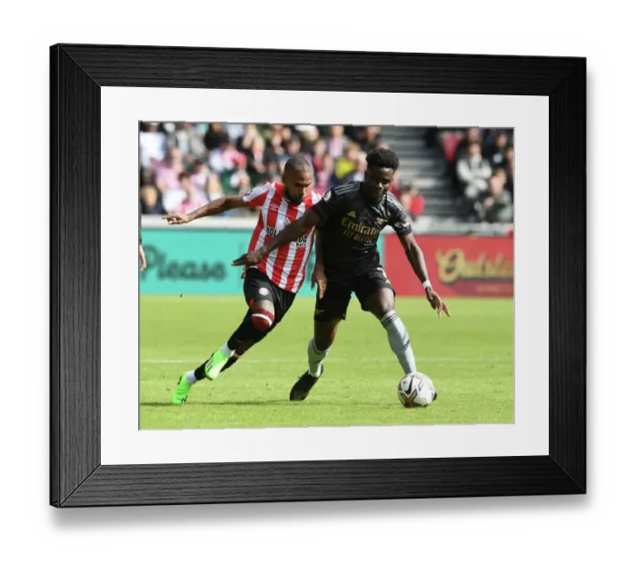 Framed Print : Bukayo Saka vs. Rico Henry: A Fierce Battle in the 2022-23 Premier League Clash between Brentford and Arsenal Framed Print : Bukayo Saka vs. Rico Henry: A Fierce Battle in the 2022-23 Premier League Clash between Brentford and Arsenal
