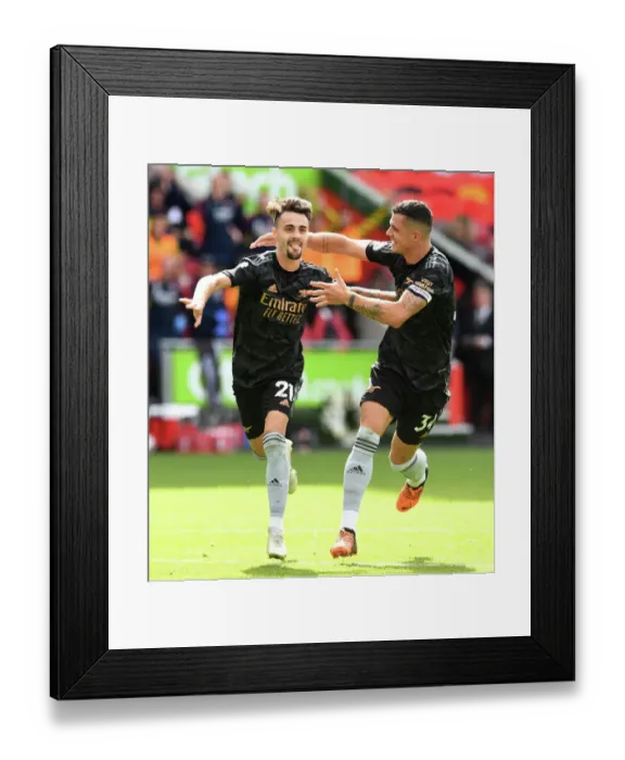 Framed Print : Triumphant Moment: Fabio Vieira and Granit Xhaka Celebrate Arsenal's Goals Against Brentford (2022-23)