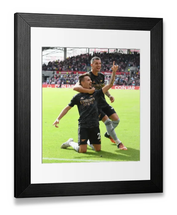 Framed Print : Arsenal's Unstoppable Duo: Fabio Vieira and Granit Xhaka Celebrate Their Third Goal Against Brentford (2022-23)