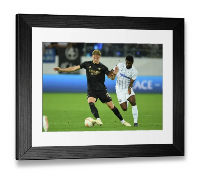Framed Print : Arsenal's Rob Holding Locks Eyes with FC Zurich's Tosin Aiyegun in Europa League Clash