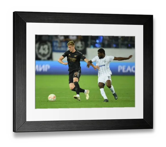 Framed Print : Arsenal's Rob Holding Intensely Focuses on FC Zurich's Tosin Aiyegun during Europa League Clash Framed Print : Arsenal's Rob Holding Intensely Focuses on FC Zurich's Tosin Aiyegun during Europa League Clash