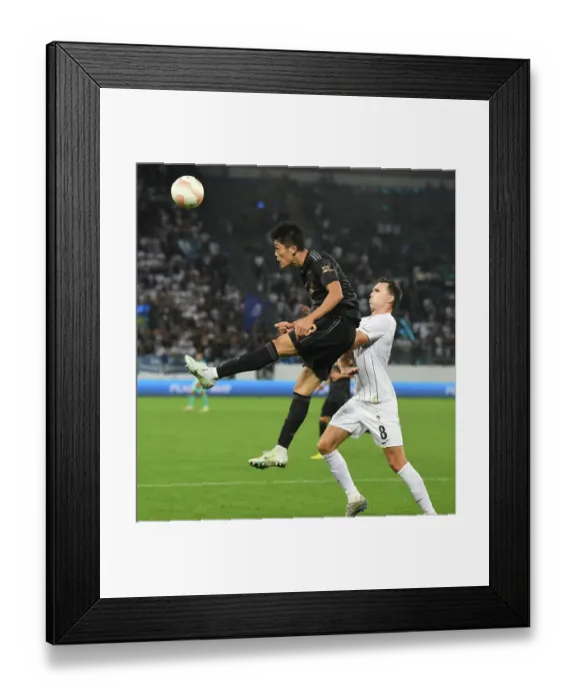 Framed Print : Arsenal's Tomiyasu Soars Over Zurich's Selnaes in Europa League Clash