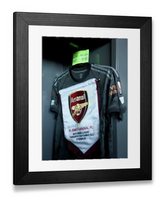 Framed Print : Arsenal FC Prepares for UEFA Europa League Clash against FC Zurich: Match Pennant and Captains Armband in the Changing Room Framed Print : Arsenal FC Prepares for UEFA Europa League Clash against FC Zurich: Match Pennant and Captains Armband in the Changing Room