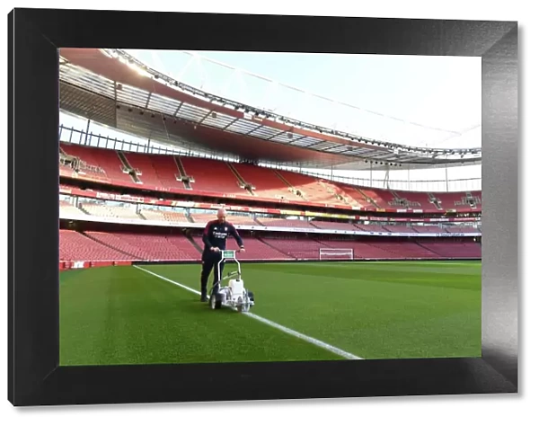 Arsenal v Tottenham: Preparing for Battle - Premier League 2022-23: Arsenal Groundsman Marks Out the Emirates Stadium Pitch