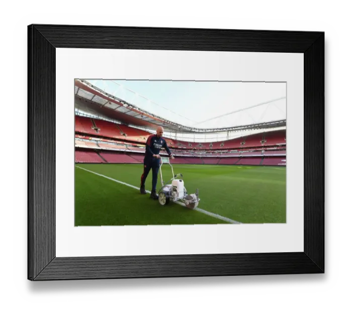 Framed Print : Battle Lines Drawn: Arsenal Groundsman Prepares Arsenal's Turf for the Big Match vs. Tottenham