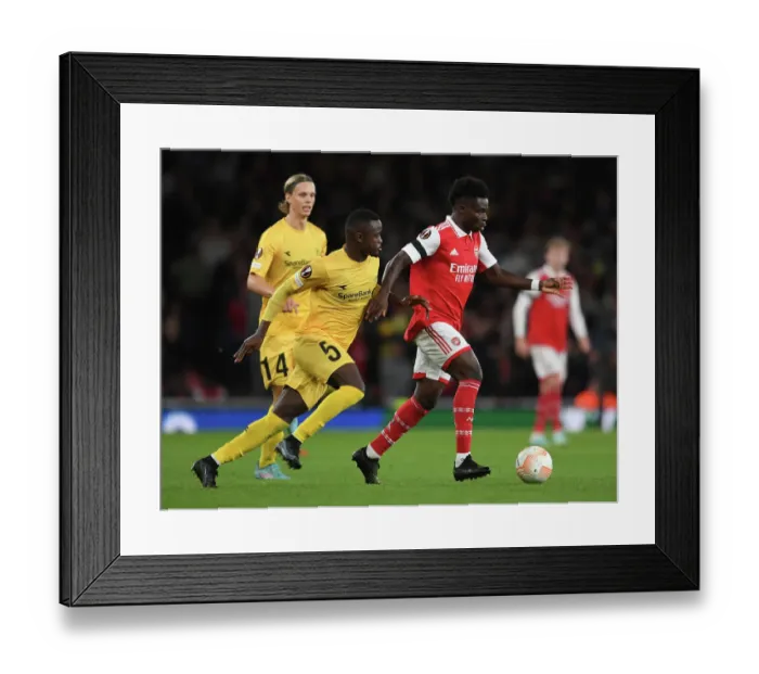 Framed Print : Arsenal's Bukayo Saka Clashes with Brice Wenbangomo in Europa League Battle Framed Print : Arsenal's Bukayo Saka Clashes with Brice Wenbangomo in Europa League Battle
