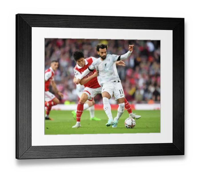 Framed Print : Tomiyasu Stifles Salah: Arsenal vs. Liverpool's Intense Battle (2022-23)