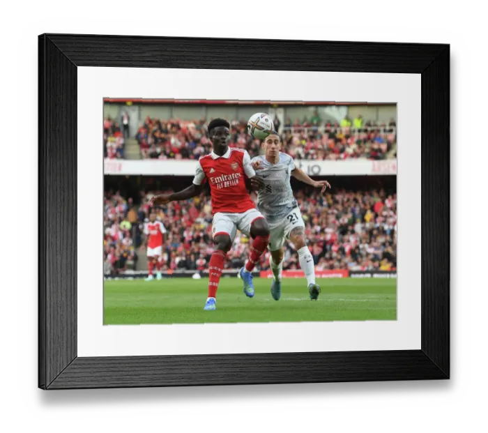 Framed Print : Arsenal's Bukayo Saka Faces Off Against Liverpool in the Premier League Framed Print : Arsenal's Bukayo Saka Faces Off Against Liverpool in the Premier League