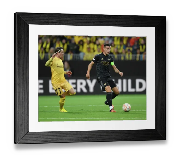 Framed Print : Granit Xhaka Breaks Past Opponent in Arsenal's UEFA Europa League Clash vs. Bodø / Glimt