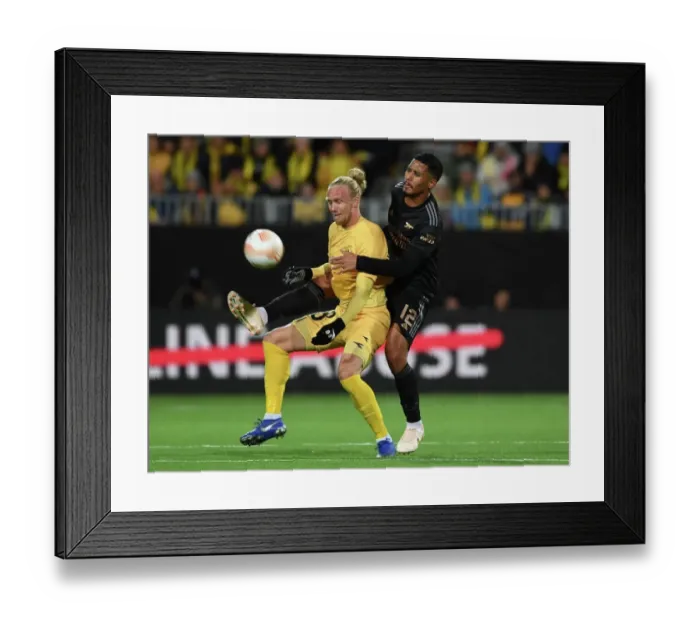 Framed Print : Arsenal's William Saliba Faces Off Against Bodo / Glimt's Lars Salvesen in Europa League Clash