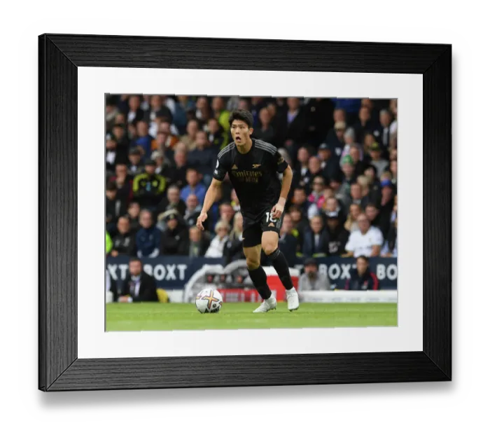 Framed Print : Arsenal's Tomiyasu Faces Off Against Leeds United in Premier League Clash Framed Print : Arsenal's Tomiyasu Faces Off Against Leeds United in Premier League Clash