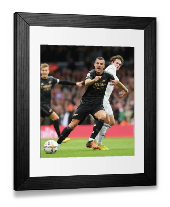 Framed Print : Xhaka vs Aaronson: Intense Battle in Leeds United vs Arsenal FC Premier League Clash