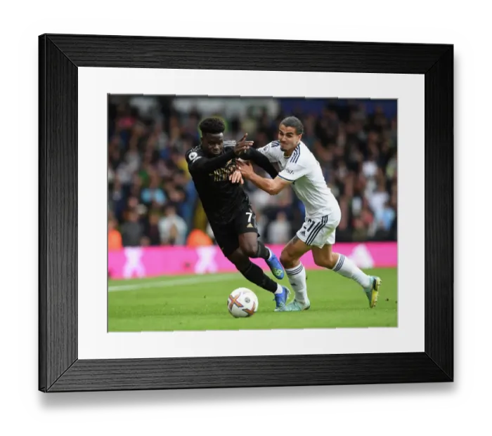 Framed Print : Saka vs Struijk: Battle at Elland Road - Leeds United vs Arsenal FC, Premier League 2022-23