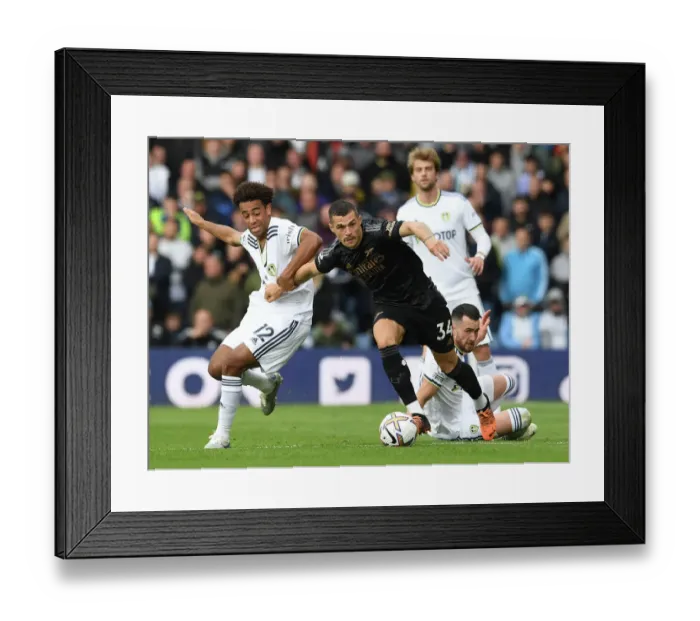 Framed Print : Xhaka Clashes with Leeds Duo: Leeds United vs Arsenal FC, Premier League 2022-23