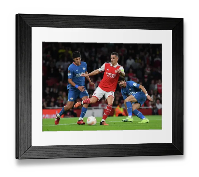 Framed Print : Arsenal vs PSV Eindhoven: Granit Xhaka Fends Off Pressure in Europa League Clash Framed Print : Arsenal vs PSV Eindhoven: Granit Xhaka Fends Off Pressure in Europa League Clash