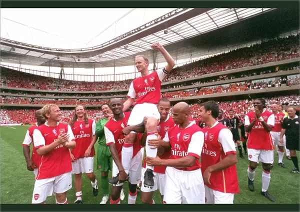 Dennis Bergkamp is chaired by Patrick Vieira and Thierry Henry and the rest of the Arsenal Legends