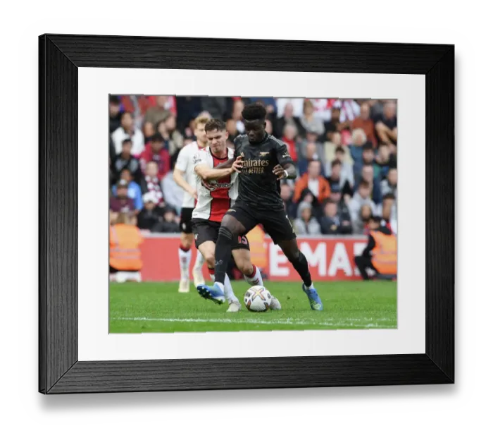 Framed Print : Saka vs Perraud: Battle at St. Mary's - Southampton vs Arsenal, 2022-23 Premier League