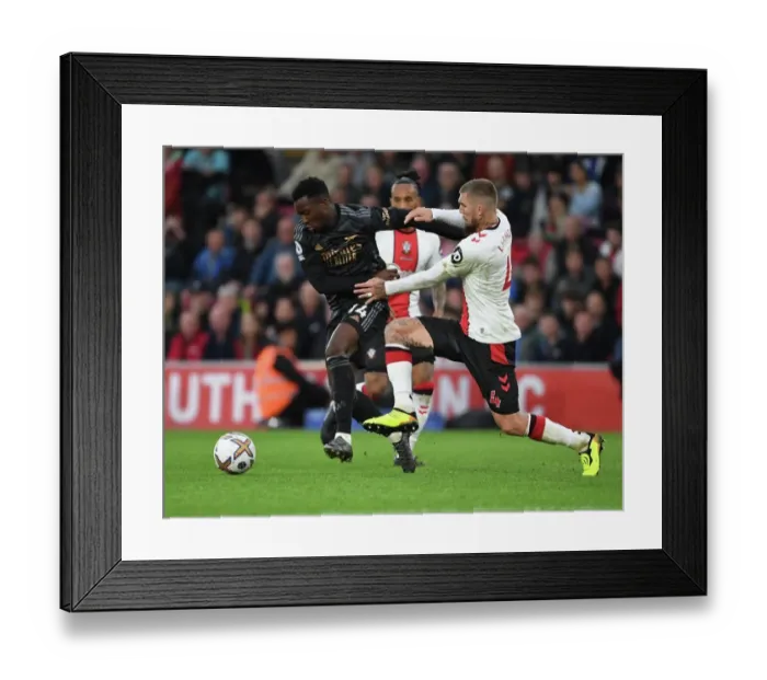 Framed Print : Arsenal's Eddie Nketiah Outmaneuvers Southampton's Lyanco in Premier League Clash