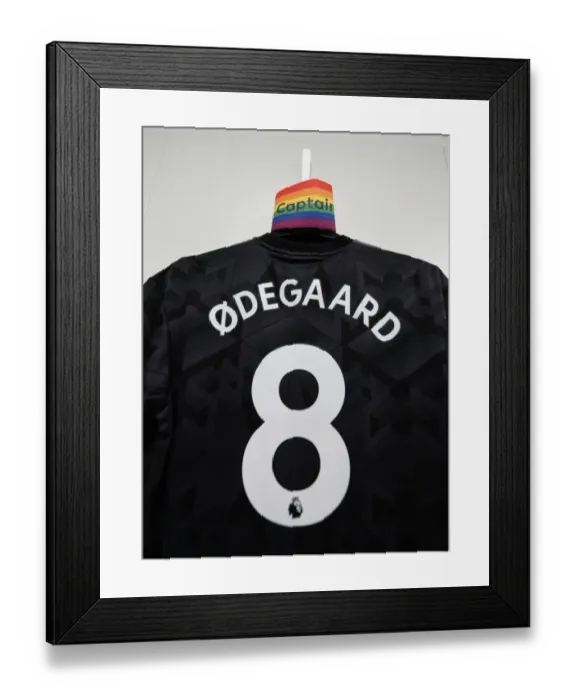 Framed Print : Arsenal's Odegaard Prepares for Southampton Clash: Captain's Armband and Shirt in Changing Room