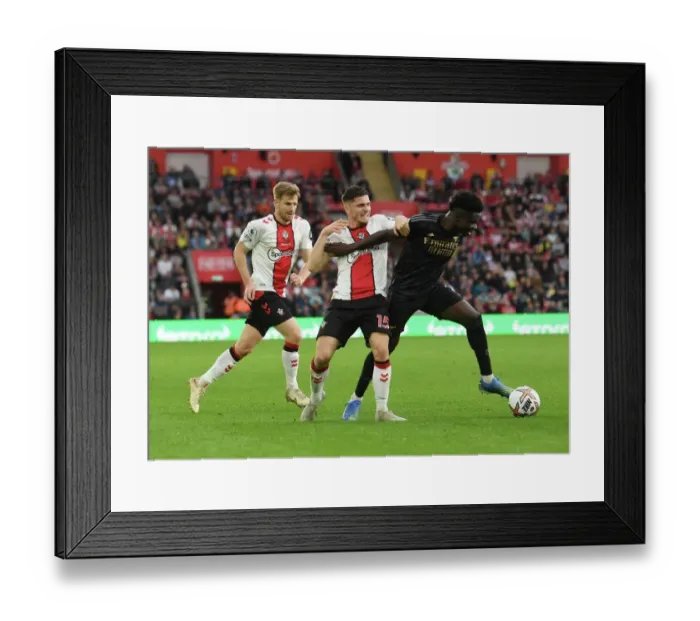 Framed Print : Saka vs Perraud: Intense Battle in Southampton v Arsenal Premier League Clash