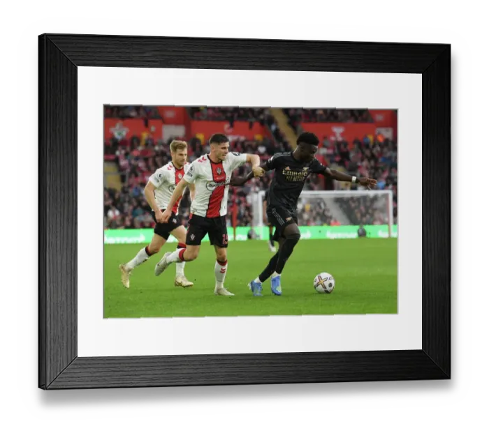 Framed Print : Saka vs Perraud: A Footballing Battle in the Southampton vs Arsenal Premier League Clash (2022-23)