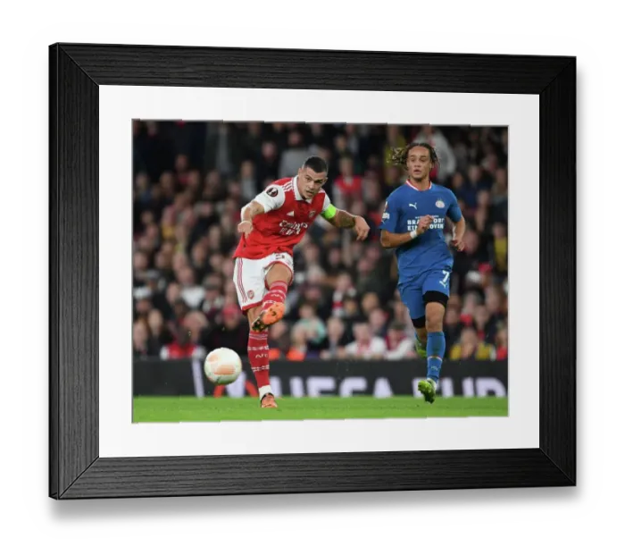 Framed Print : Granit Xhaka Takes On Xavi Simons: Arsenal vs PSV Eindhoven, UEFA Europa League 2022-23 Framed Print : Granit Xhaka Takes On Xavi Simons: Arsenal vs PSV Eindhoven, UEFA Europa League 2022-23