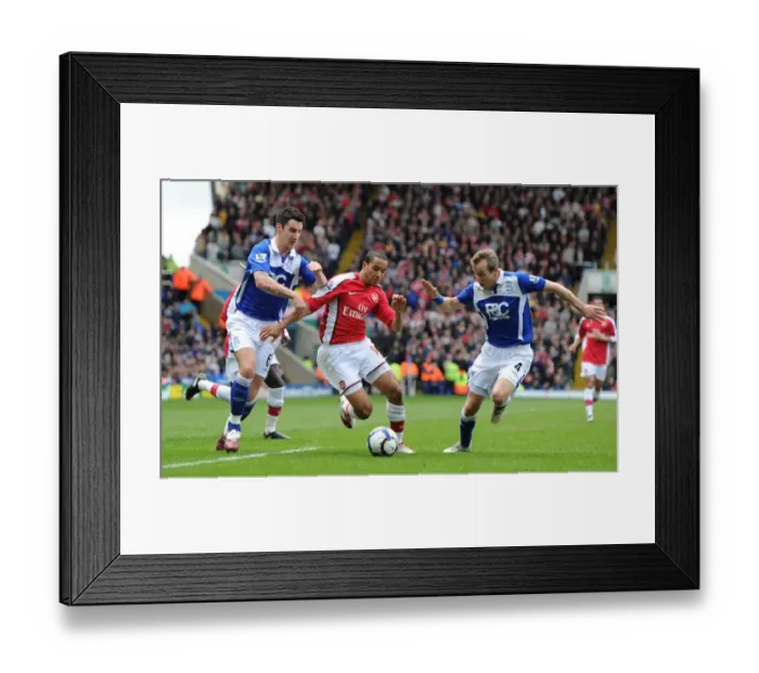 Framed Print : Theo Walcott Faces Off Against Birmingham Duo Liam Ridgewell and Lee Bowyer in Intense Barclays Premier League Clash
