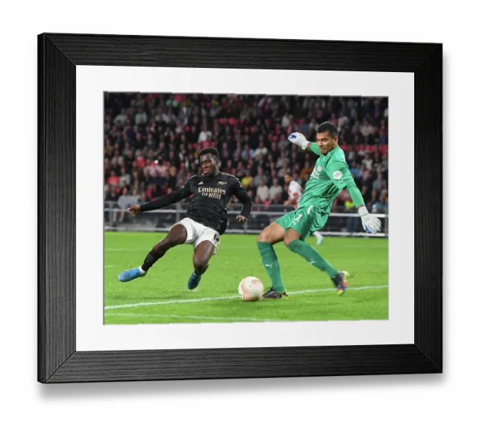 Framed Print : Arsenal's Eddie Nketiah Closes In on PSV Goalkeeper during Europa League Clash Framed Print : Arsenal's Eddie Nketiah Closes In on PSV Goalkeeper during Europa League Clash