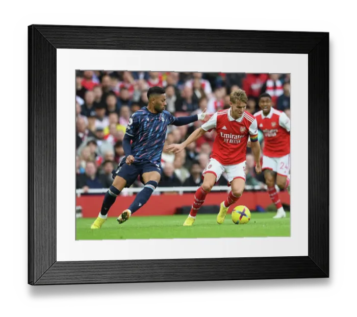 Framed Print : Intense Battle: Odegaard Denies Lodi in Arsenal's Victory over Nottingham Forest (2022-23)