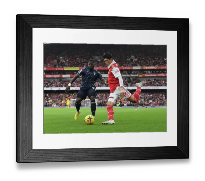 Framed Print : Arsenal's Tomiyasu Outmaneuvers Aurier in Premier League Clash vs. Nottingham Forest Framed Print : Arsenal's Tomiyasu Outmaneuvers Aurier in Premier League Clash vs. Nottingham Forest