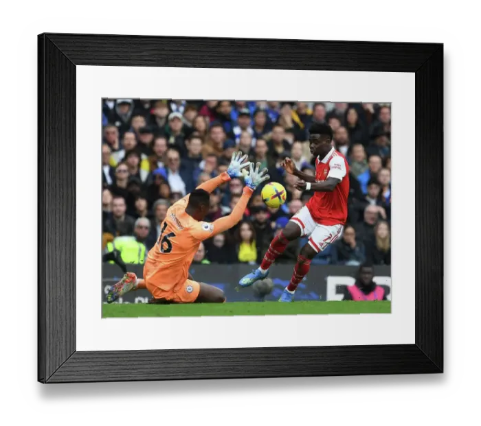 Framed Print : Clash at Stamford Bridge: Arsenal's Bukayo Saka vs. Chelsea's Edouard Mendy