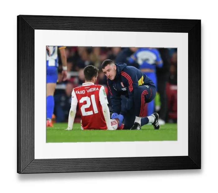 Framed Print : Arsenal's Fabio Vieira Receives Treatment vs Brighton in Carabao Cup