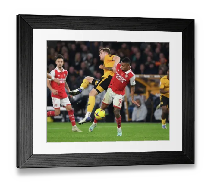 Framed Print : Gabriel Jesus vs. Nathan Collins: A Clash of Strength in the Wolverhampton Wanderers vs. Arsenal FC Showdown