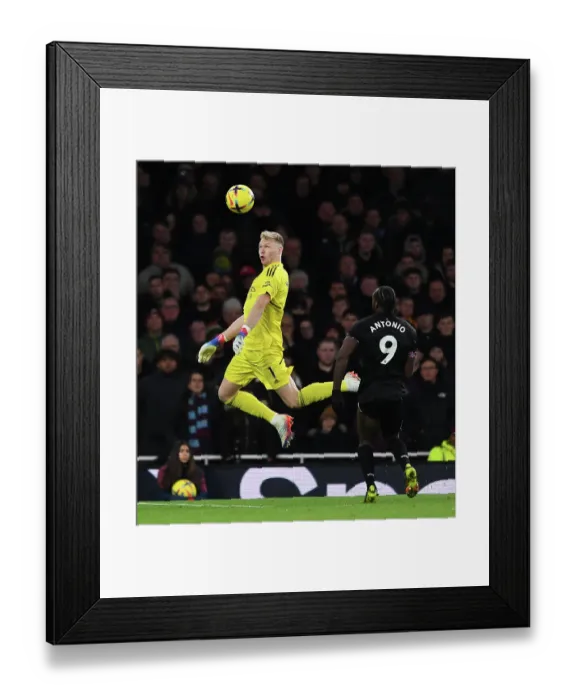 Framed Print : Arsenal's Ramsdale Fends Off West Ham's Antonio: A Headed Battle in the Premier League