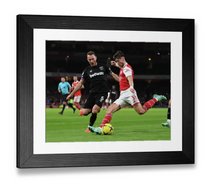 Framed Print : Arsenal's Kieran Tierney Fends Off West Ham's Vladimir Coufal in Premier League Clash