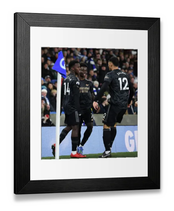Framed Print : Saka, Nketiah, and Saliba: Arsenal's Triple Threat Celebrates First Goal in Brighton Victory (Brighton & Hove Albion vs Arsenal, 2022-23 Premier League)