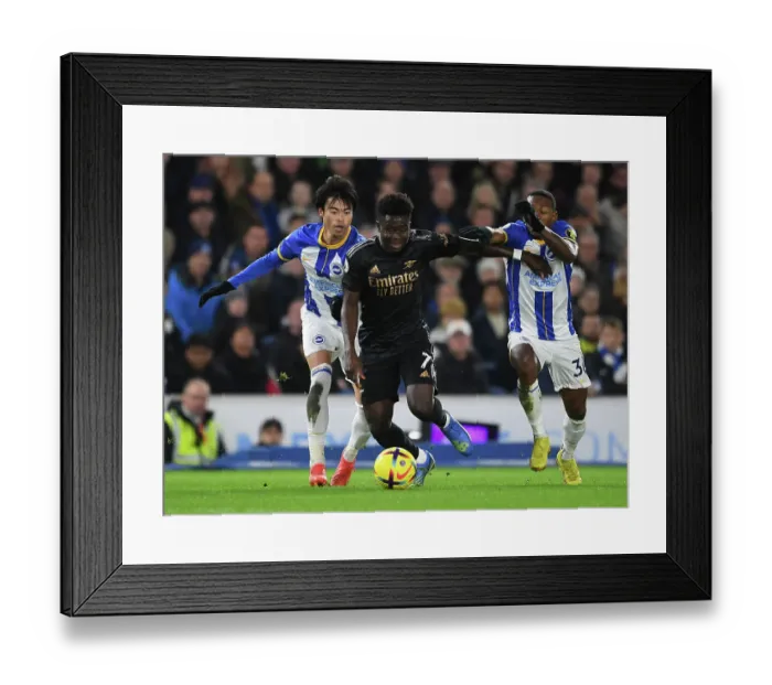 Framed Print : Bukayo Saka Faces Off Against Brighton's Mitoma and Estupinan in Arsenal's Premier League Clash