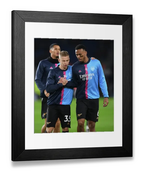 Framed Print : Arsenal Players Gabriel Magalhaes and Oleksandr Zinchenko Warm Up Ahead of Brighton & Hove Albion Clash (Premier League 2022-23)