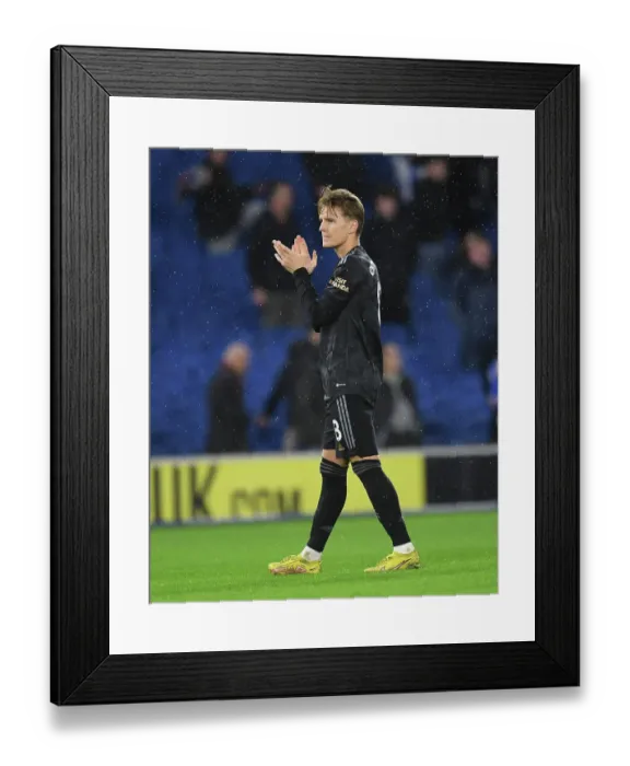 Framed Print : Arsenal's Martin Odegaard Celebrates with Fans after Brighton Victory - Premier League 2022-23